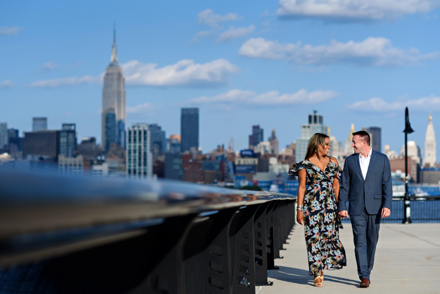 A couple talke a walk along the hudson river in Hoboken, NJ.